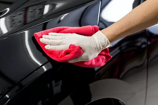 Closeup of hand cleaning black car