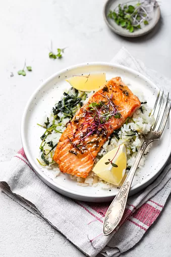 Grilled salmon steak with lemon rice and spinach