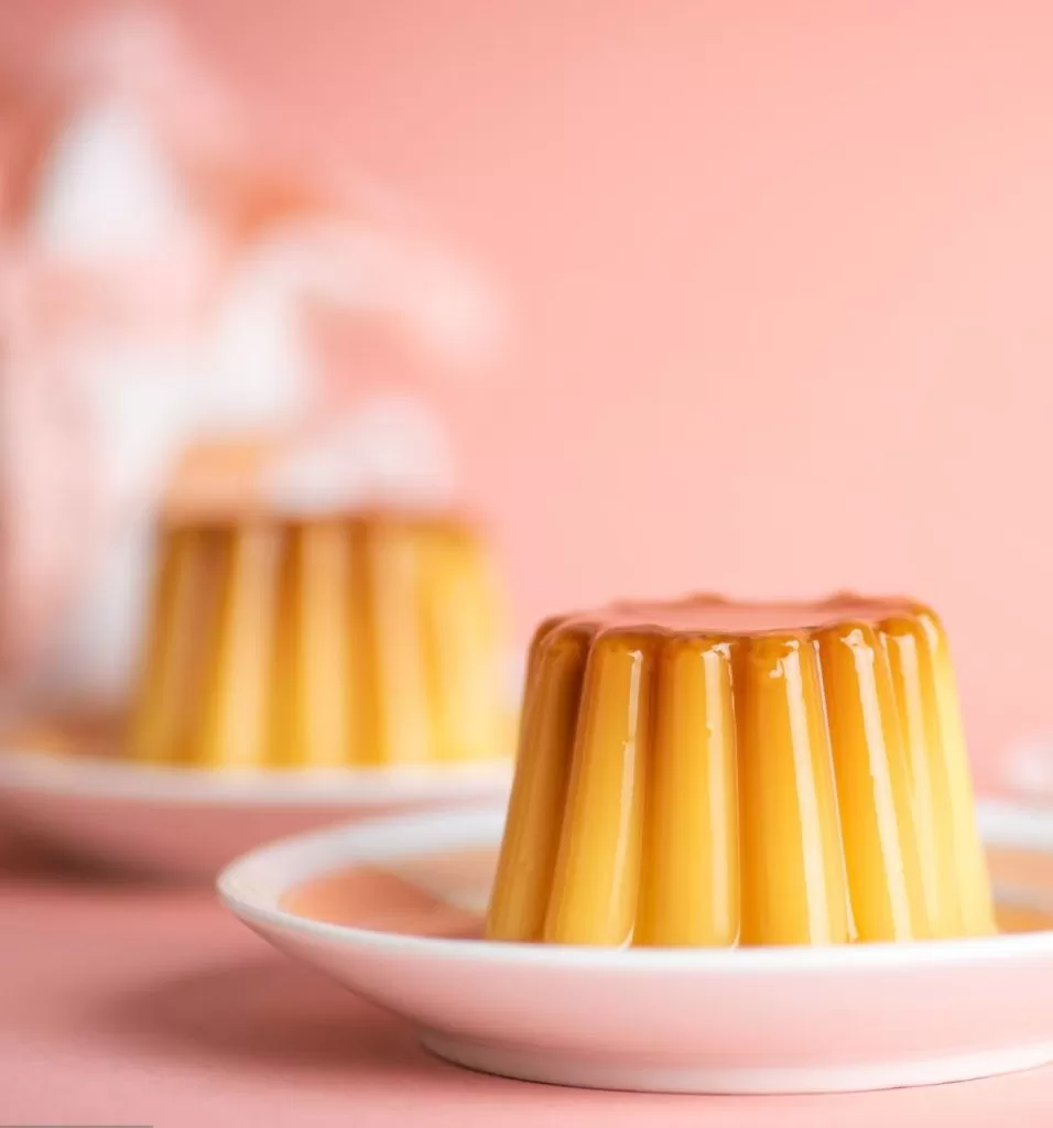 Homemade pudding soft vanilla dessert in cup mold shape on a plate